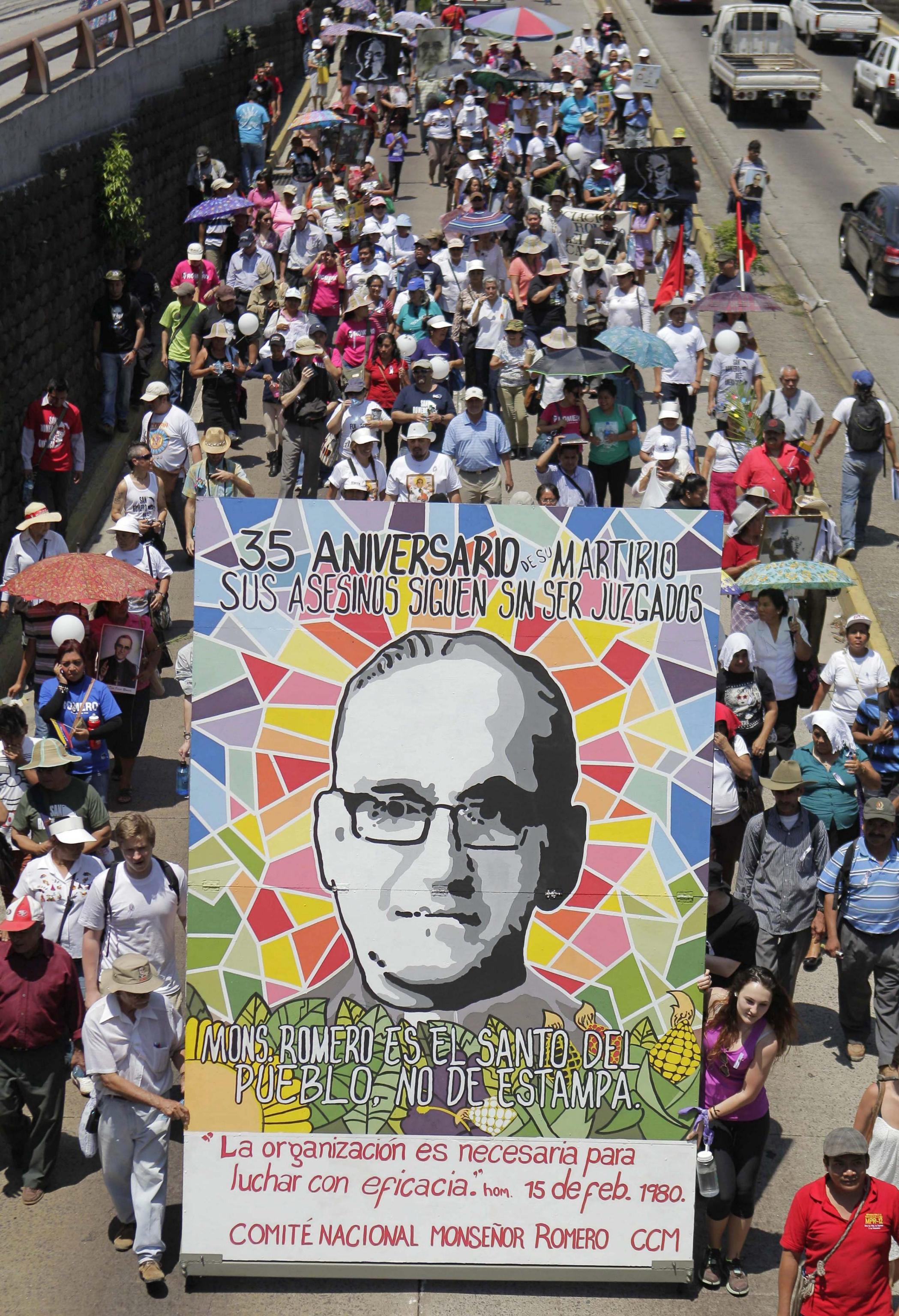 Salvadoreans take part in the march commemorating the 35th anniversary of the assassination of Archbishop Oscar Arnulfo (24th of March 1980)