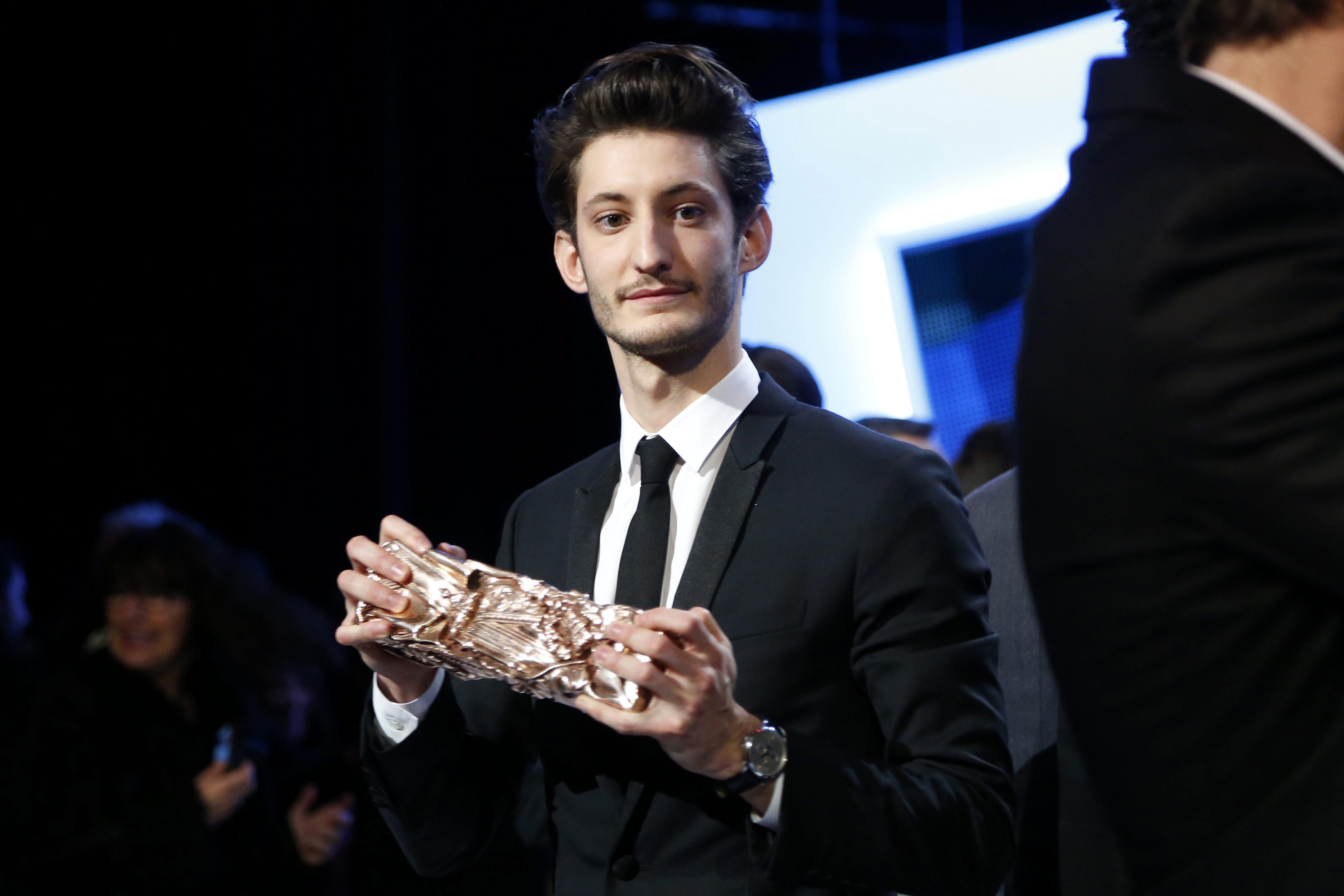 French actor Pierre Niney poses with his award after the 40th annual Cesar awards ceremony held at the Chatelet Theatre in Paris