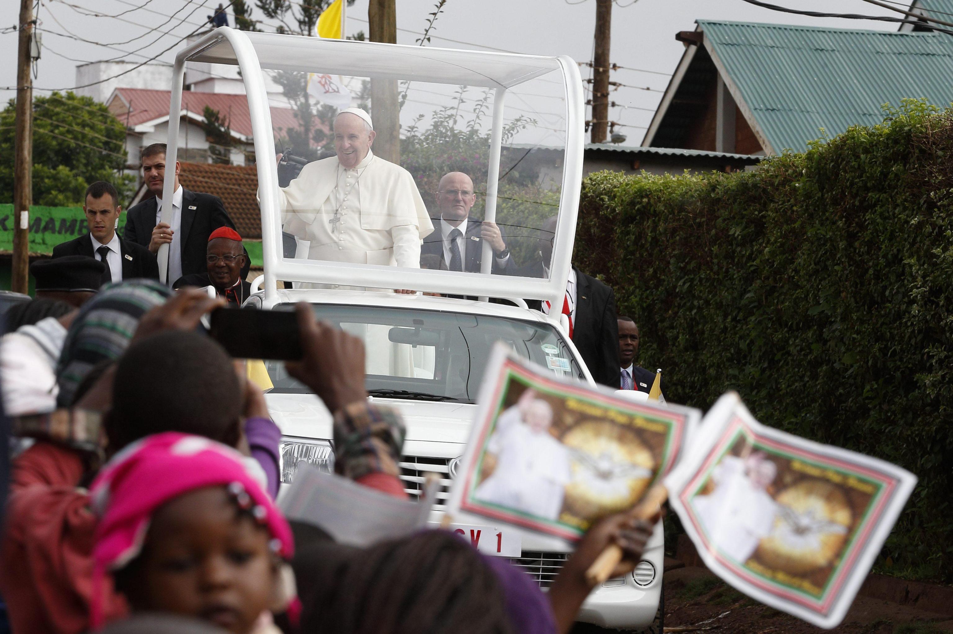 Pope Francis arrives to visit a Catholic parish in the Kangemi slum on the outskirts of Nairobi