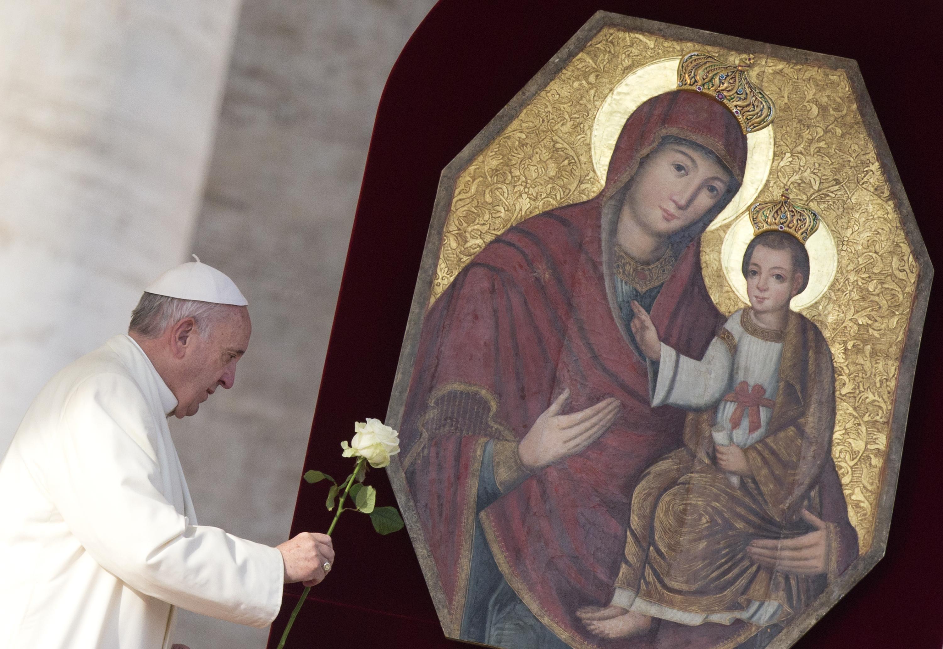 Pope Francis presents a rose at image of Holy Mary and Child Jesus prior his Wednesday General Audience