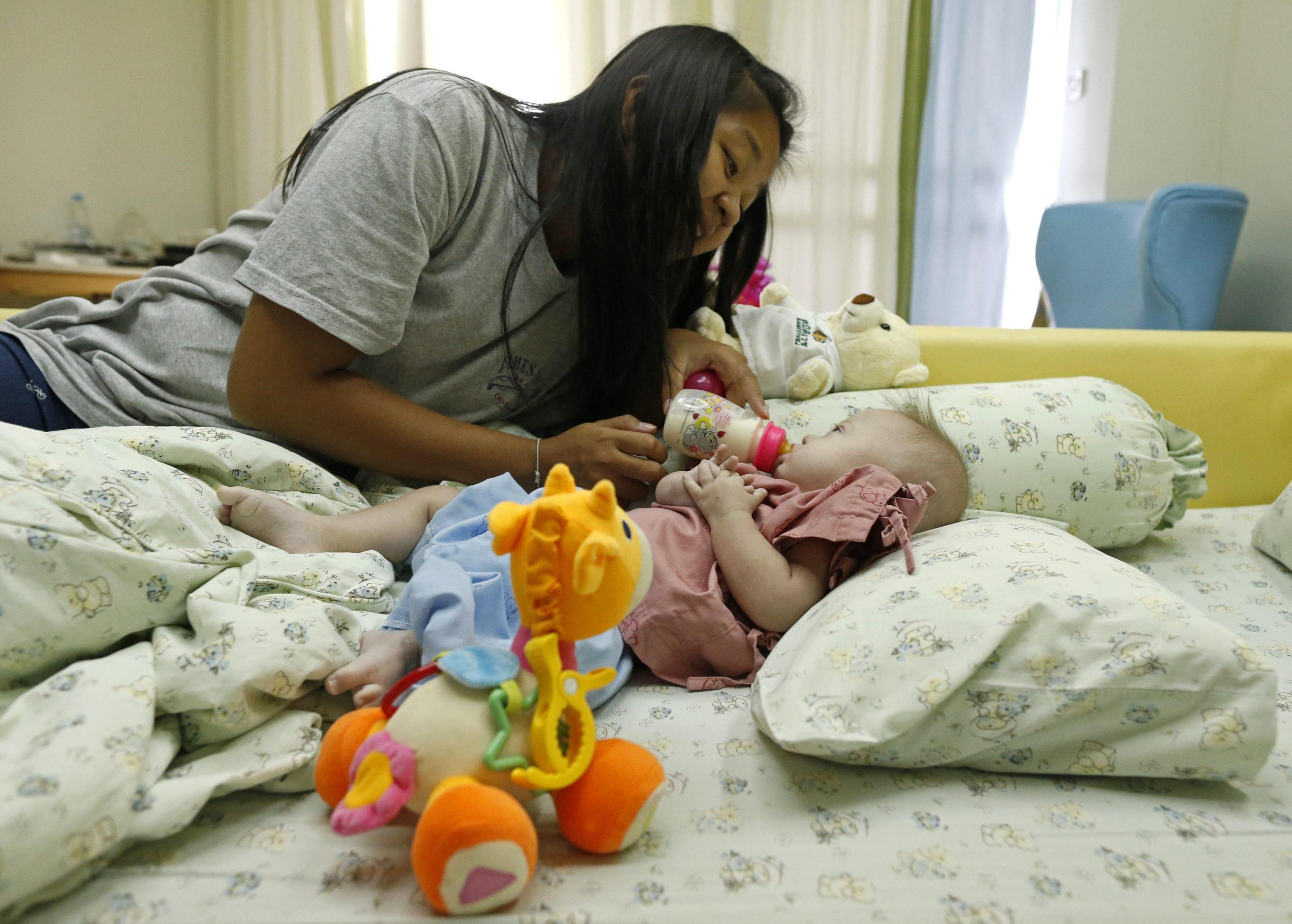 Thai surrogate mother Pattharamon Janbua with her seven-month-old Down's Syndrome baby