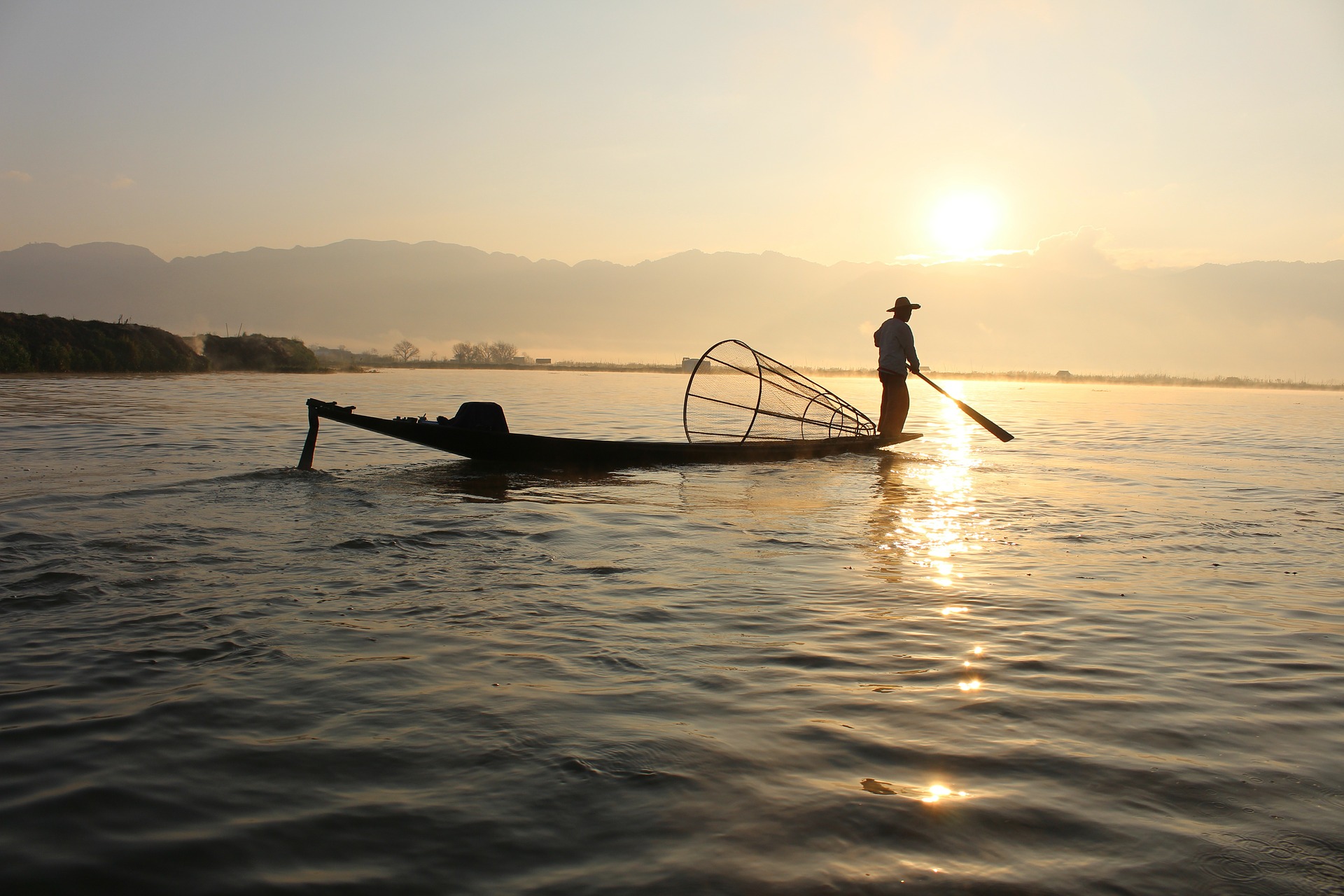 A fisherman in his boat on the Lake Inle