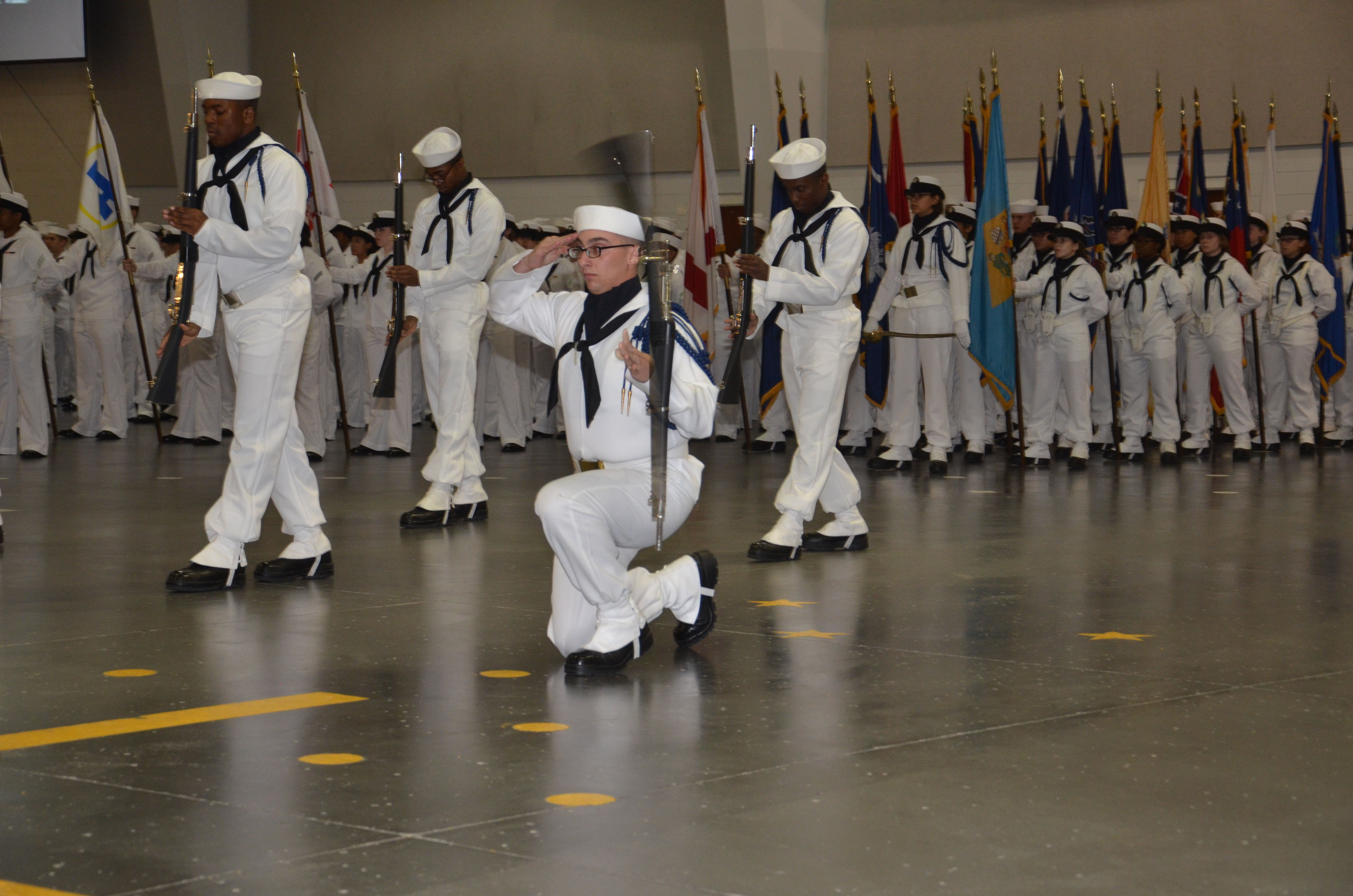 A U.S. Navy recruit rifle drill team performs during pass in review May 24