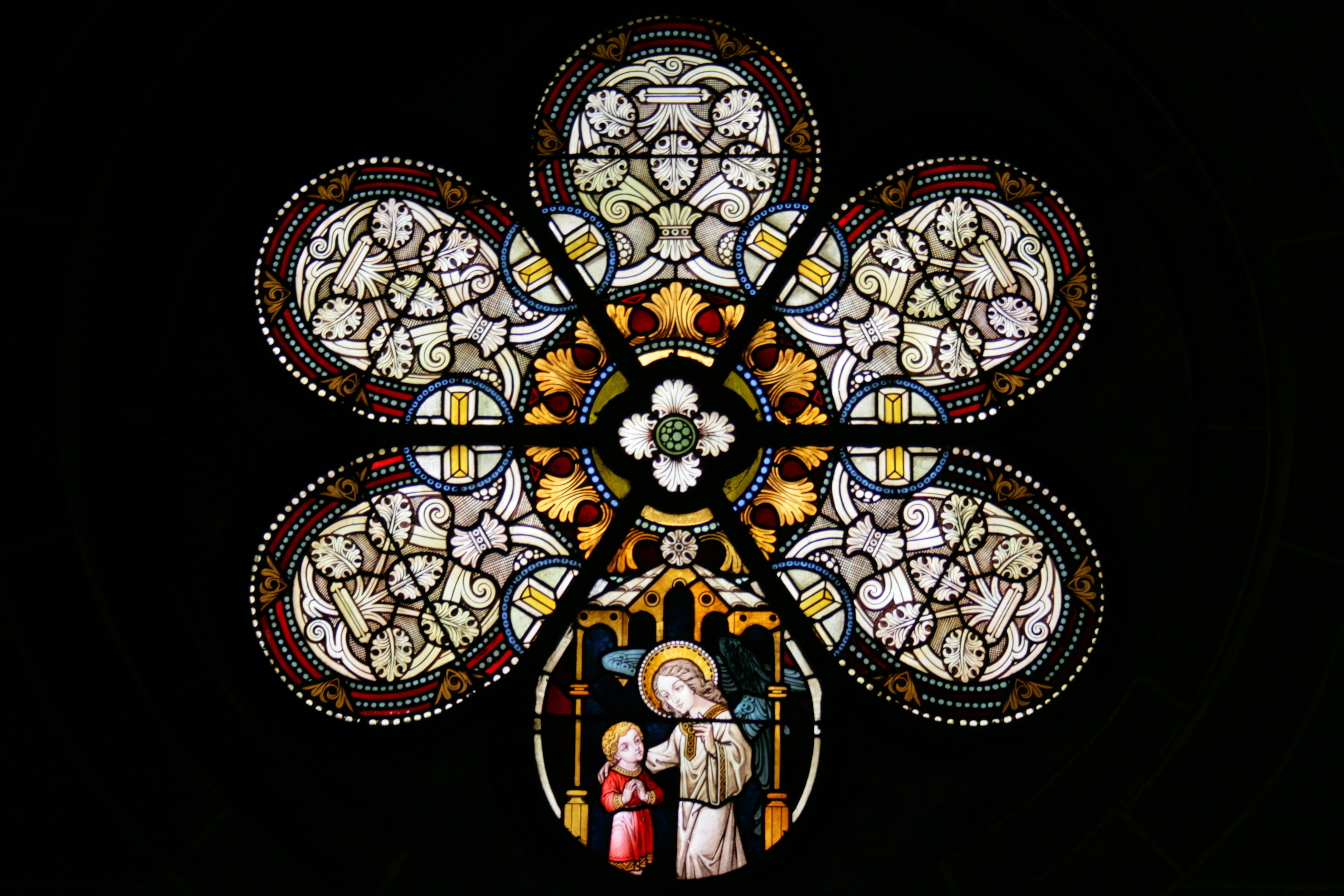 Stained glass window showing guardian angel in St. Laurence church
